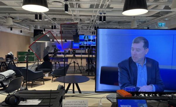 Business leaders participate in live event broadcast from office